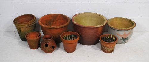 A quantity of various sized terracotta garden plant pots and some glazed, including a strawberry