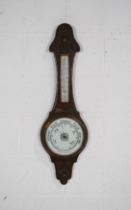 A carved oak wall hanging barometer - height 88cm