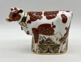 A Royal Crown Derby Daisy cow paperweight with gold stopper - 15 cm high.