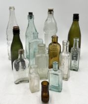 A collection of vintage glass bottles including Kidderminster, OK Sauce, Camp coffee etc.