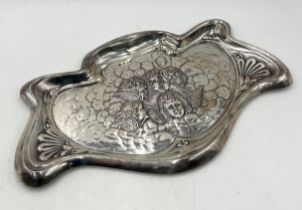 A hallmarked silver shaped dressing table tray decorated with cherubs, weight 249g