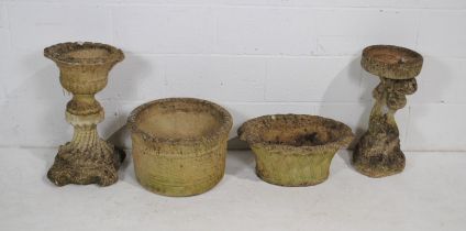 Two large reconstituted stone garden plant pots, along with a weathered bird bath on cherub base and