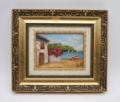 A gilt framed oil on board of a house by the sea, with indistinct signature - 26cm x 30cm