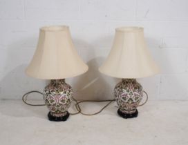 A pair of ceramic table lamps, decorated with vine leaves