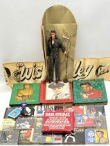 An assortment of Elvis Presley memorabilia including three scrapbooks of vintage newspaper &