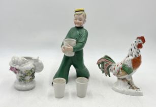 A small collection of continental china including decanter in the form of a bell boy etc.