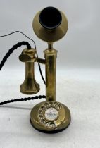 A vintage brass stick telephone