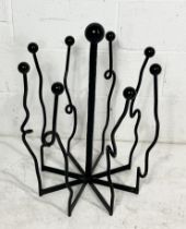A cast iron boot stand/rack with twisted detail