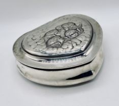 A large hallmarked silver heart shaped jewellery box decorated with cherubs