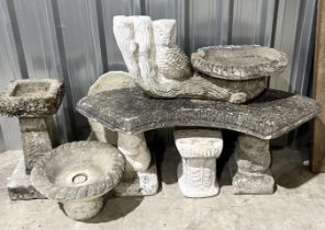 A collection of garden ornaments including a bench, sectional birdbath, planters etc.