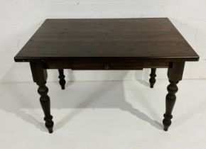 A stained pine table with drawer to front. 87cm x 122cm, height 79cm