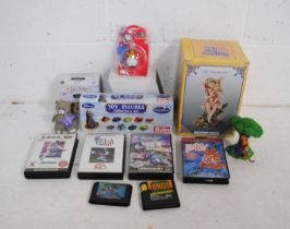 A mixed lot including a small quantity of Sega Mega Drive games, boxed Disney toy figures collectors