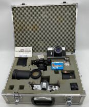 Three vintage cameras- Zenit EM (Moscow Olympics), Praktica B200 and a Praktica MTL3 along with