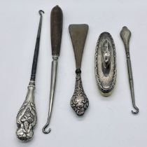 A hallmarked silver nail buffer along with silver handled boot hooks and shoe horn