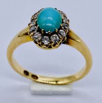 An 18ct gold cluster ring set with turquoise and a surround of diamonds, size L 1/2