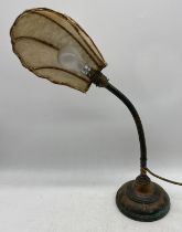 A turn of the century adjustable copper table lamp
