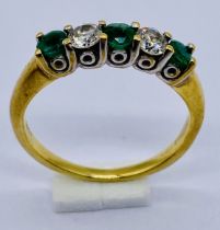 An 18ct gold diamond and emerald 5 stone ring, size J 1/2