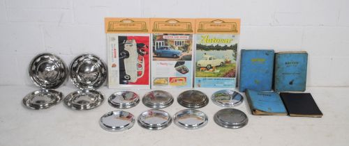 Three sets of vintage chrome car hubcaps, including Austin, along with four workshop manuals and