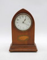 An Edwardian mantel clock, with inlaid central shell motif, raised on brass ball feet
