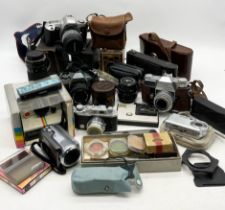 A collection of various vintage cameras and accessories including Kodak Retina Reflex III,