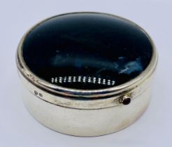 A hallmarked silver pill pot with gilded interior