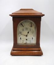 An oak chiming mantel clock, with silvered dial, with keys