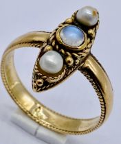 An antique 15ct gold (tested) ring set with a moonstone flanked by two pearls, size P 1/2