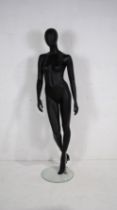 A retail female full body shop display mannequin on tempered glass stand by 'Window Mannequins' -