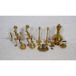 A quantity of brass items, including two pairs of candlesticks, a pair of fire dogs, a large Eastern