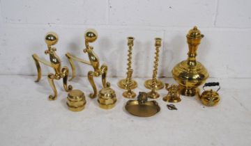 A quantity of brass items, including two pairs of candlesticks, a pair of fire dogs, a large Eastern