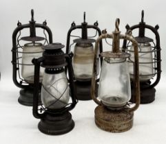 A collection of five vintage oil lanterns including one dated 1941, Gremlin etc.
