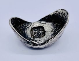 A Chinese silver boat shaped ingot, impressed character marks, weight 69.5g