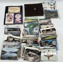 A collection of vintage postcards together with an album of photographs showing a trip to South