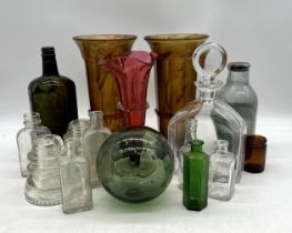 A collection of vintage art glass including cranberry and smokey glass, bottles etc