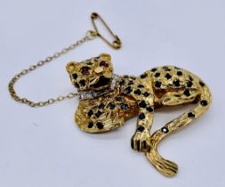 A 9ct gold brooch in the form of a Leopard set with sapphire and diamonds to eyes and collar (1