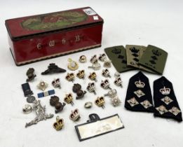 A collection of vintage military buttons, badges epaulettes etc.