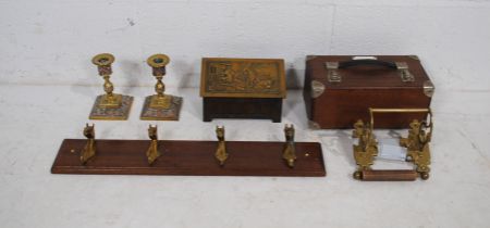 A pair of antique brass candlesticks, along with a vintage biscuit tin, coat hooks, brass toilet