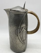 A Tudric hammered pewter hot water jug, pattern 0231, designed by Archibald Knox