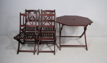 A folding wooden octagonal garden table with four chairs