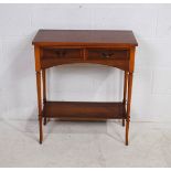 A small yew side table, with two drawers, raised on tapering legs with splayed feet - length 66cm,