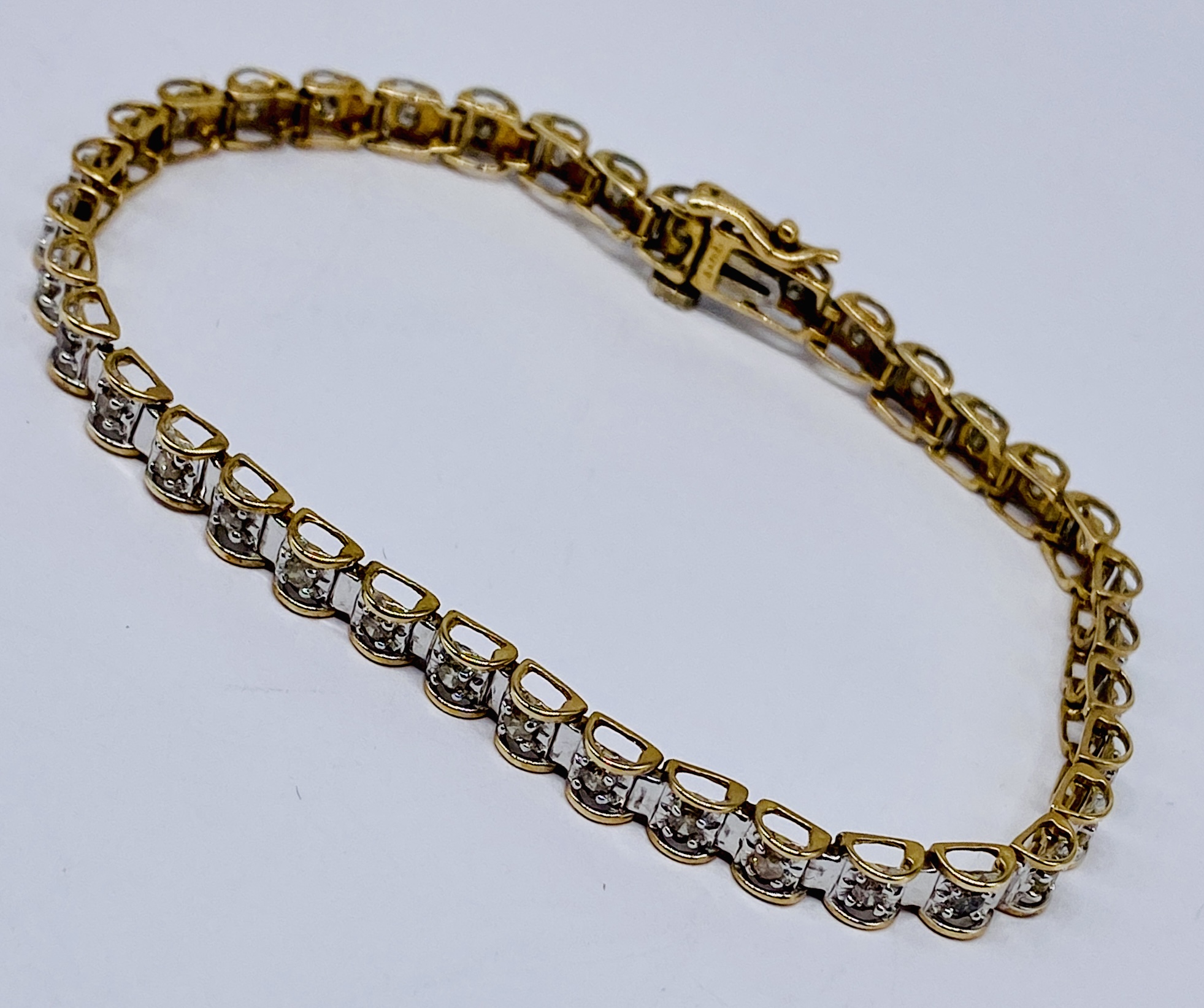 A 9ct gold tennis bracelet set with diamonds