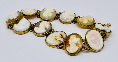 An unmarked yellow metal bracelet with numerous cameos (1 link loose)