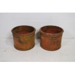 A pair of large weathered terracotta garden pots of cylindrical form - diameter 50cm, height 39cm