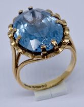 A 9ct gold ring set with a large blue stone, size M