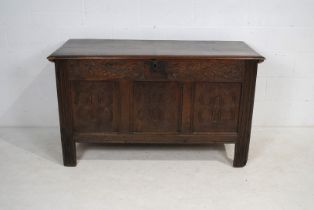 An antique oak coffer, with carved decoration - length 144cm, depth 61cm, height 84cm