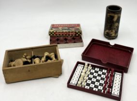 A Chinese lacquered brush pot with dragon design along with a small selection of games, chess set