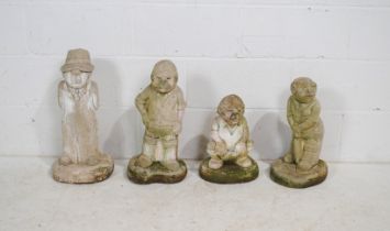 Four weathered reconstituted stone garden ornaments in the form of cricketers, including an