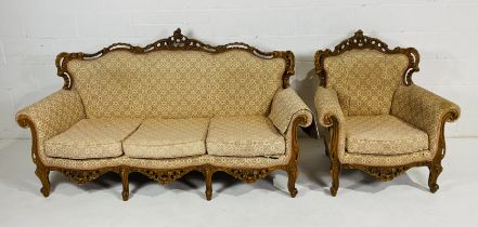 A French style settee along with a chair, both with matching upholstery and carved detailing