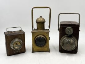 Two WW2 era Ever Ready wooden cased lamps along with a brass railway lamp