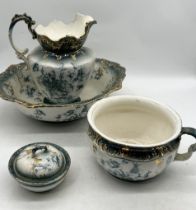 An antique green and gilt china jug and bowl set with chamberpot and brush pot